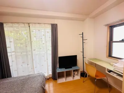 a bedroom with a bed and a desk with a television at \u30b7\u30e3\u30f3\u30c6\u9ad8\u7530\u99ac\u583432 in Tokyo