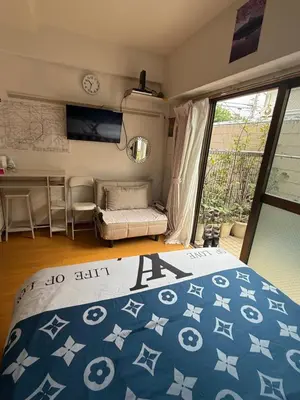 a bedroom with a bed and a couch and a table at \u6771\u4eac\u306e\u6e2f\u7063-Tokyo Harbor -28 square meter king size garden room103 in Tokyo