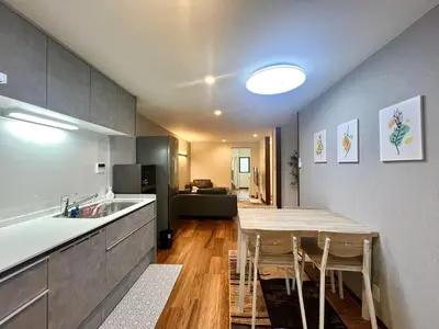 a kitchen with a table with chairs and a counter top at Kenki Asakusa House-TT0171 in Tokyo
