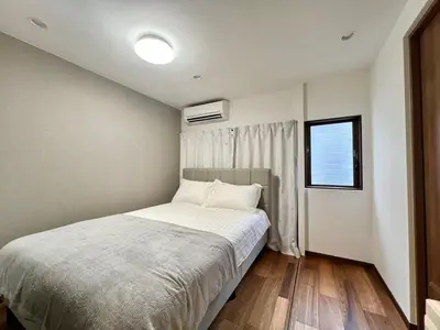 a small bedroom with a bed and a window at Kenki Asakusa House-TT0171 in Tokyo