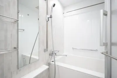 a white bathroom with a shower and a tub at MAT Shinjuku West in Tokyo