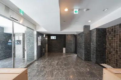 a large room with tile walls and a ceiling at MAT Shinjuku West in Tokyo