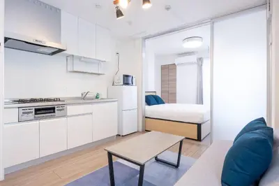 a living room with a kitchen and a bed at skye yusima in Tokyo