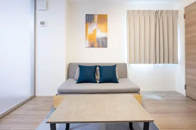 a living room with a couch and a table at skye yusima in Tokyo