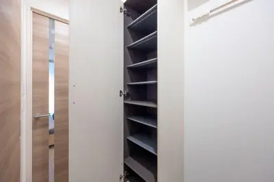 a closet with black shelves next to a door at skye yusima in Tokyo