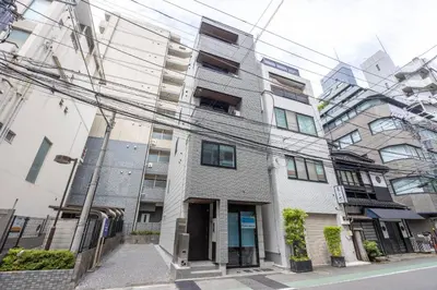 an apartment building on a street with power lines at skye yusima in Tokyo