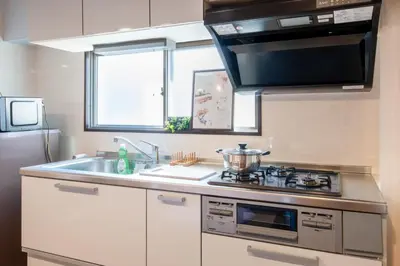 a kitchen with a sink and a stove and a microwave at \u30b5\u30cb\u30fc\u30cf\u30a4\u30c4301 in Tokyo