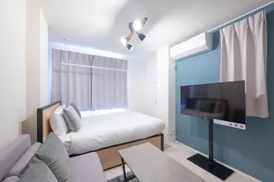 a small room with a bed and a flat screen tv at K-room in Tokyo
