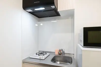 a kitchen with a sink and a microwave at Luna\u4e21\u56fd in Tokyo