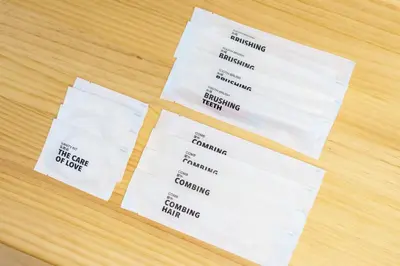 two white receipts sitting on top of a table at \u58a8\u7530\u533a\u76f4\u8fbe\u6cb3\u666f\u6c11\u5bbf in Tokyo