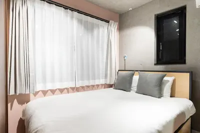 a bedroom with a large bed with a large window at Fruit Elegant in Tokyo