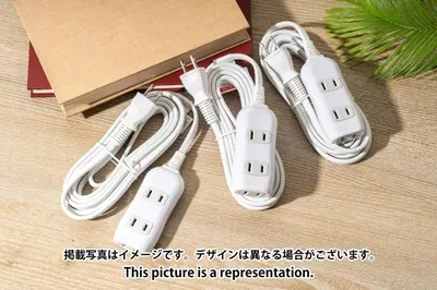 two white wii controllers sitting next to a box at Fruit Elegant in Tokyo