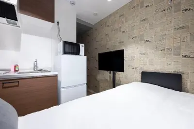a kitchen with a white refrigerator and a sink at Fruit Elegant in Tokyo