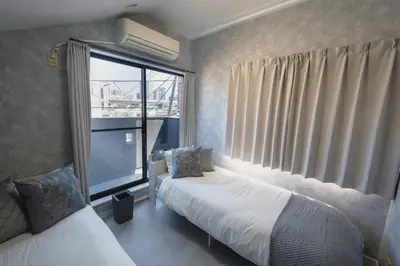 a bedroom with two beds and a large window at Pet-Friendly, Projector, 2LDK, 6pp, Shinagawa Area in Tokyo