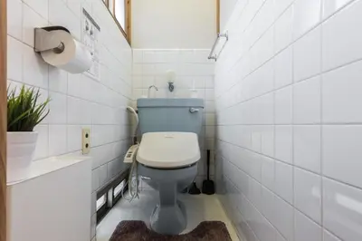 a bathroom with a blue toilet and white tiles at Samurai House - Vacation STAY 54179v in Tokyo