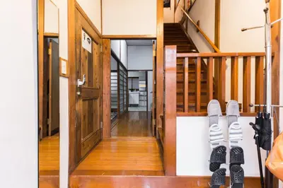 a pair of shoes hanging on a wall next to a staircase at Samurai House - Vacation STAY 54179v in Tokyo