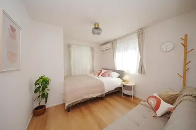 a bedroom with a bed and a couch at Jacky's House Yahiro in Tokyo