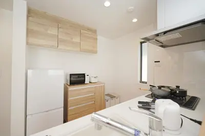 a kitchen with a sink and a stove top oven at Jacky's House Yahiro in Tokyo