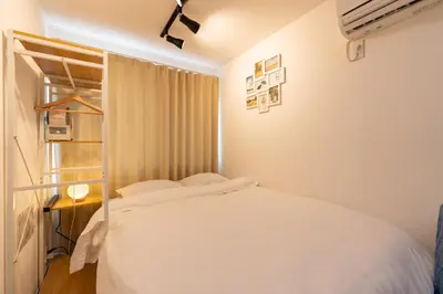 a bedroom with a white bed and a window at AsahiStay -Asakusa, Self check in & Well located house in Tokyo
