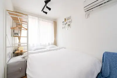 a white bedroom with a white bed and a window at AsahiStay -Asakusa, Self check in & Well located house in Tokyo