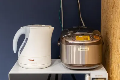a slow cooker and a toaster sitting on a shelf at AsahiStay -Asakusa, Self check in & Well located house in Tokyo