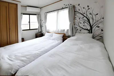 two beds sitting next to each other in a bedroom at Largo in Tokyo