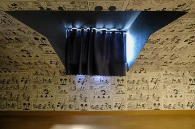 a stage with black curtains on a wall with writing at Largo in Tokyo