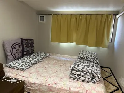 a bedroom with a bed with pillows and a window at \u5343\u99c4\u6728\u306e\u52c7 in Tokyo