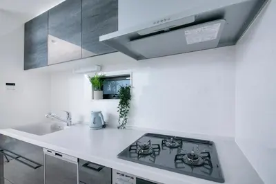 a white kitchen with a stove and a sink at pufuka Higashi Mukojima 4 in Tokyo