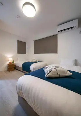 a bedroom with two beds and a large window at pufuka Higashi Mukojima 4 in Tokyo