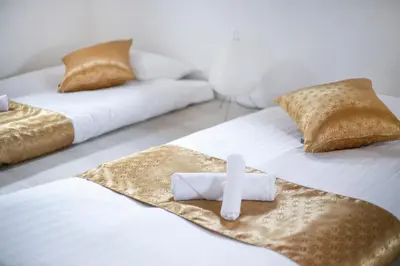 two beds with a cross sitting on top of them at pufuka Higashi Mukojima 4 in Tokyo