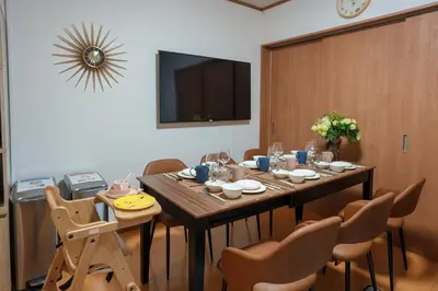 a dining room with a table with chairs and a television at Room 201 - Itabashi Minamicho - Diamond Yu in Tokyo