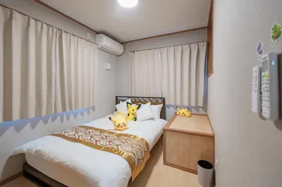 a bedroom with a bed with three cats on it at Room 201 - Itabashi Minamicho - Diamond Yu in Tokyo