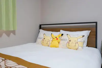 three stuffed animals sitting on pillows on a bed at Room 202 - Itabashi Minamicho - Diamond Yu in Tokyo