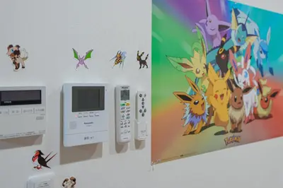a wall with a nintendo wii controller and a picture of a cartoon at Room 202 - Itabashi Minamicho - Diamond Yu in Tokyo