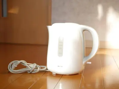 a white jug sitting on a table with a cord at Amika First301 AF31 in Tokyo