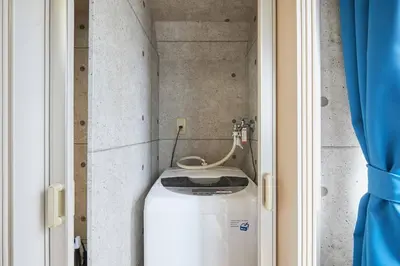 a small bathroom with a washing machine in a room at Amika First301 AF31 in Tokyo