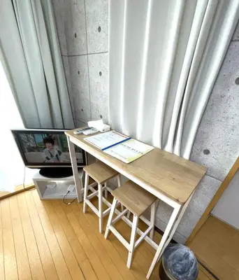 a desk in a room next to a curtain at Amika First 303 AF33 in Tokyo