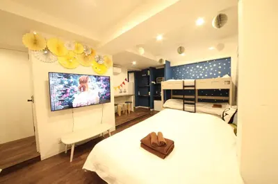 a bedroom with a bed and a flat screen tv at Shibuya Wave 101 in Tokyo