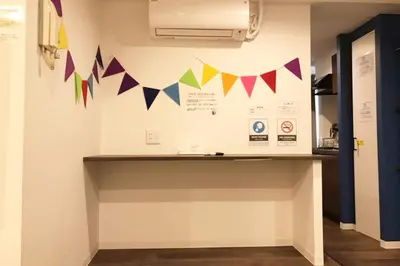 a room with a counter with flags on the wall at Shibuya Wave 101 in Tokyo