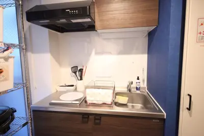 a small kitchen with a sink and a stove at Shibuya Wave 101 in Tokyo
