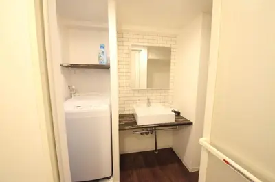 a small bathroom with a sink and a mirror at Shibuya Wave 101 in Tokyo