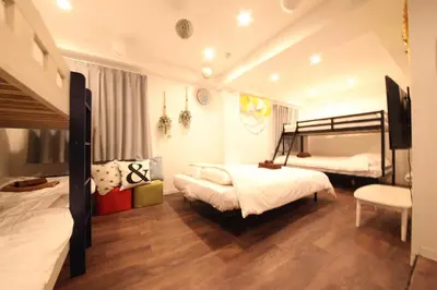 a bedroom with two beds and a tv in it at Shibuya Wave 101 in Tokyo
