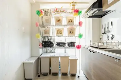 a kitchen with white cabinets and pink and green decorations at Shibuya WAVE 201 in Tokyo