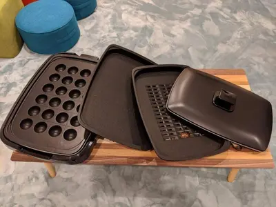 a telephone sitting on top of a wooden table at Shibuya WAVE 201 in Tokyo