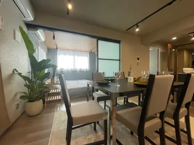 a dining room with a dining table and chairs at NiHITARU Stay in Tokyo