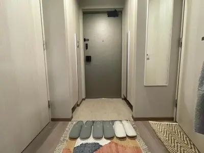 a hallway with a bed in the middle of a room at NiHITARU Stay in Tokyo