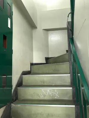 a set of stairs in a building with graffiti at Shateray Yoyogi 301 in Tokyo