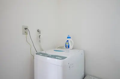 a white refrigerator with a bottle on top of it at Shateray Yoyogi 301 in Tokyo