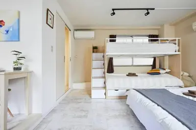a bedroom with two bunk beds in a room at Shateray Yoyogi 301 in Tokyo
